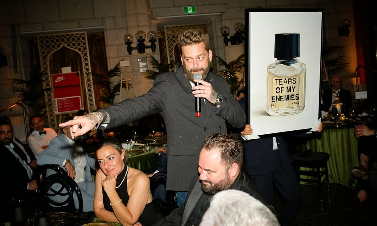 Auction host presenting artwork to guests